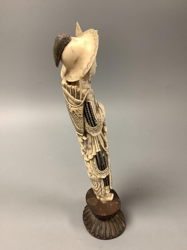 A Chinese ivory figure of Hua Mulan, early 20th century, height 26cm including wood stand